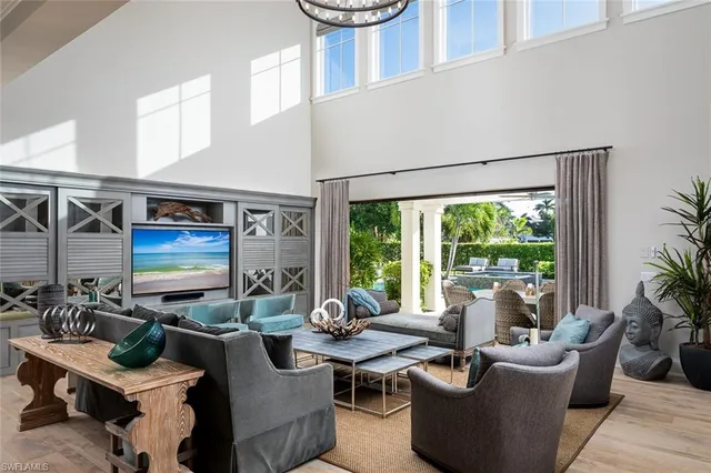 a living room with fireplace furniture and a large window