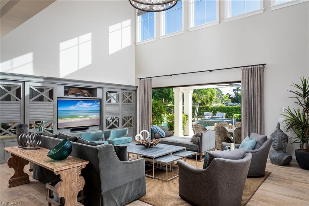 a living room with fireplace furniture and a large window