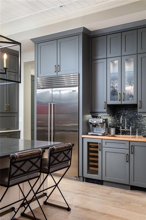 3170 Crayton Road Naples, FL 34103 - Photo 12 of 50 a kitchen with a stove a refrigerator and cabinets