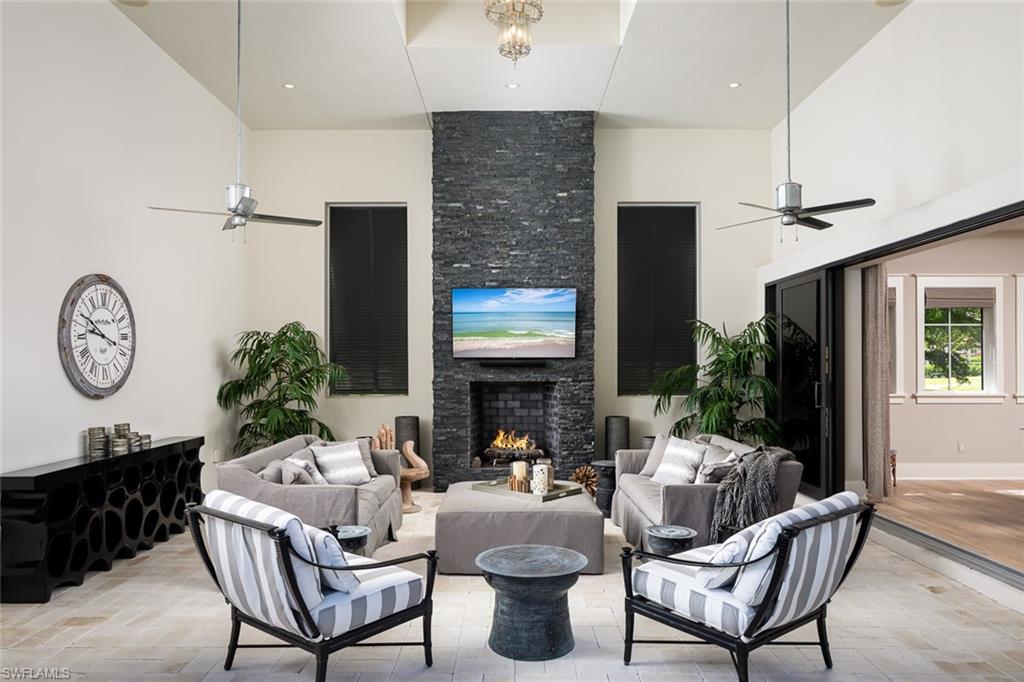 3170 Crayton Road Naples, FL 34103 - Photo 17 of 50 a living room with fireplace furniture and a large window