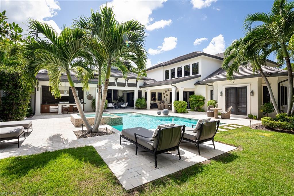 3170 Crayton Road Naples, FL 34103 - Photo 19 of 50 a view of a house with backyard sitting area and swimming pool