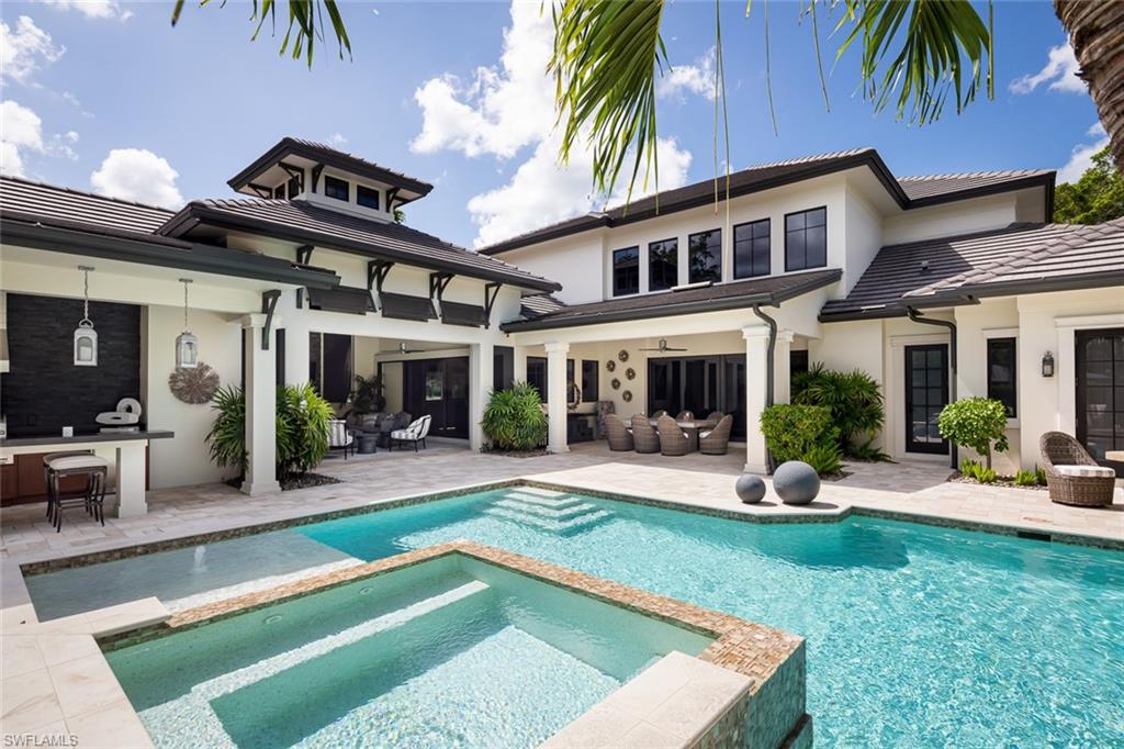 3170 Crayton Road Naples, FL 34103 - Photo 21 of 50 a view of a house with a yard patio and swimming pool