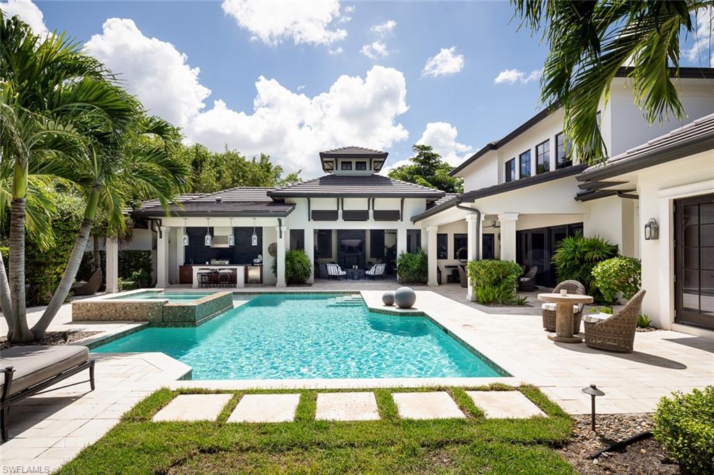 3170 Crayton Road Naples, FL 34103 - Photo 22 of 50 a front view of a house with garden and sitting area