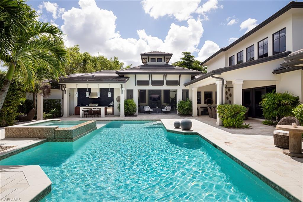 3170 Crayton Road Naples, FL 34103 - Photo 23 of 50 a view of a house with a yard patio and swimming pool