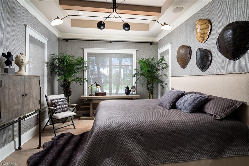 3170 Crayton Road Naples, FL 34103 - Photo 30 of 50 a bedroom with a bed and a large window