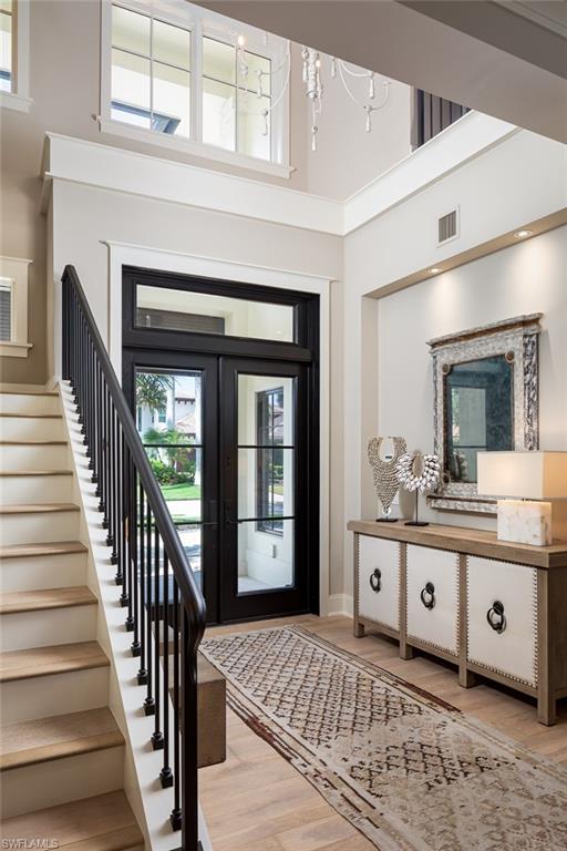 3170 Crayton Road Naples, FL 34103 - Photo 3 of 50 a living room with a bed and a large window