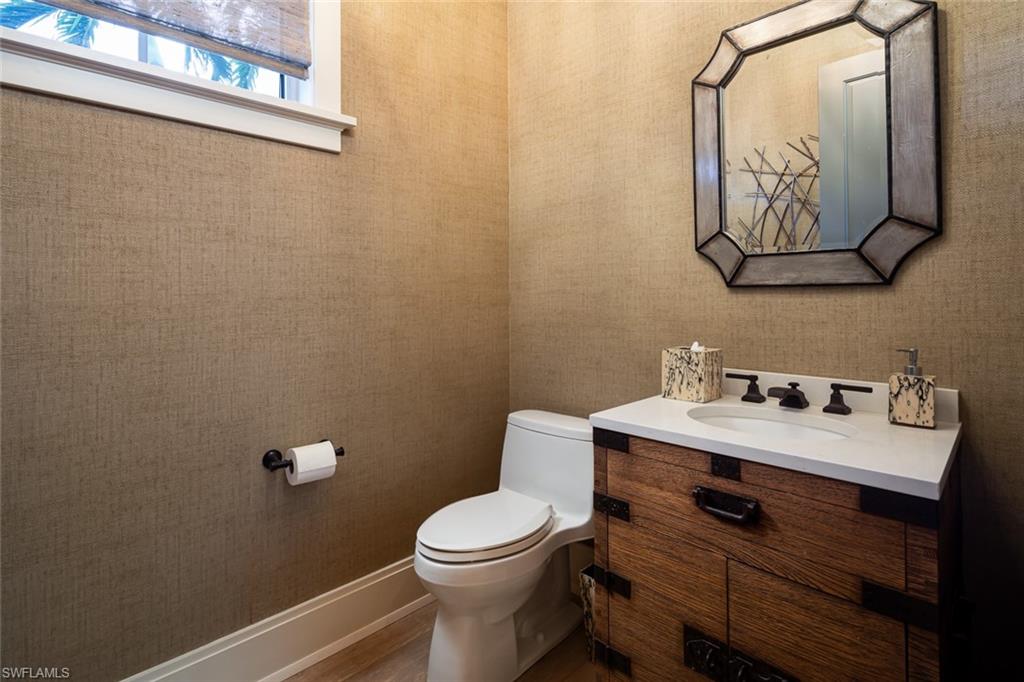 3170 Crayton Road Naples, FL 34103 - Photo 31 of 50 a bathroom with a toilet sink and mirror