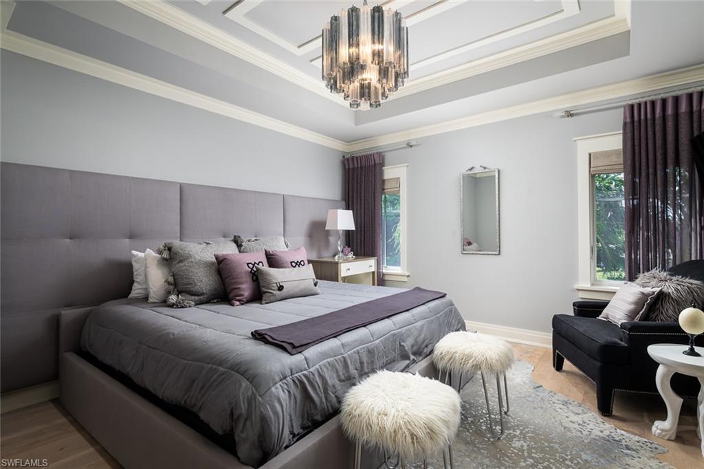 3170 Crayton Road Naples, FL 34103 - Photo 35 of 50 a bedroom with two beds and a chandelier