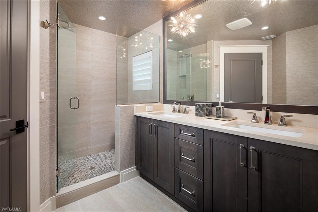 3170 Crayton Road Naples, FL 34103 - Photo 36 of 50 a bathroom with a double vanity sink mirror and shower