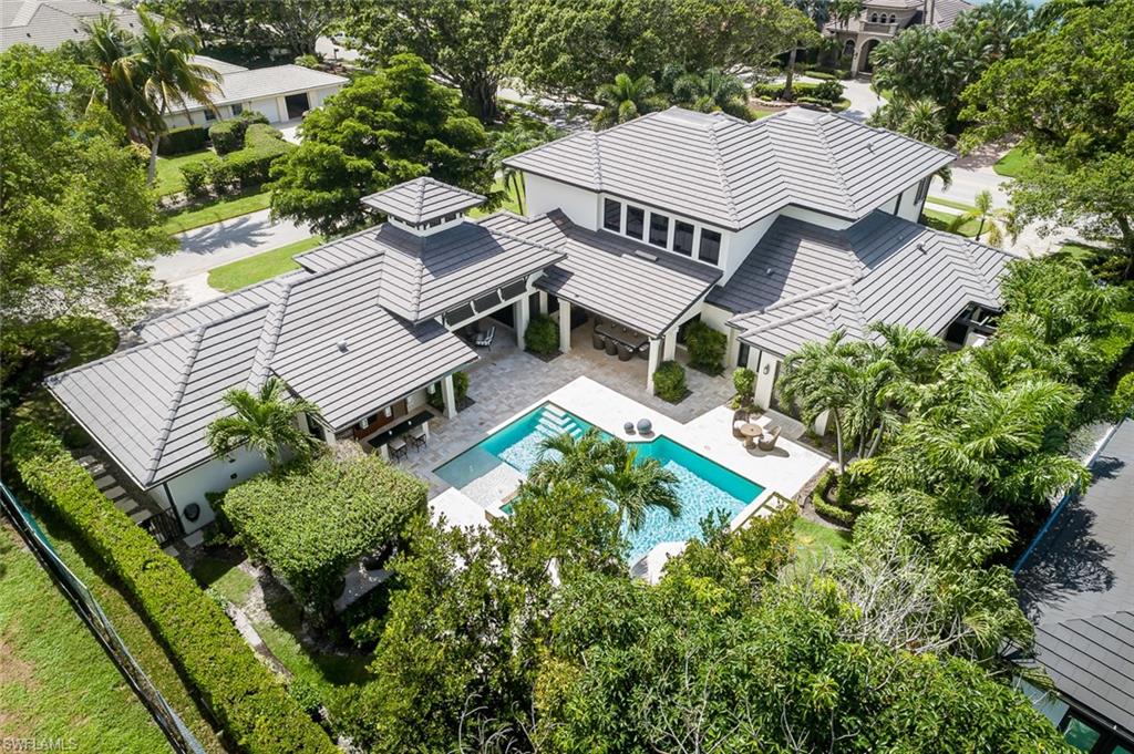3170 Crayton Road Naples, FL 34103 - Photo 40 of 50 an aerial view of multiple houses with a yard