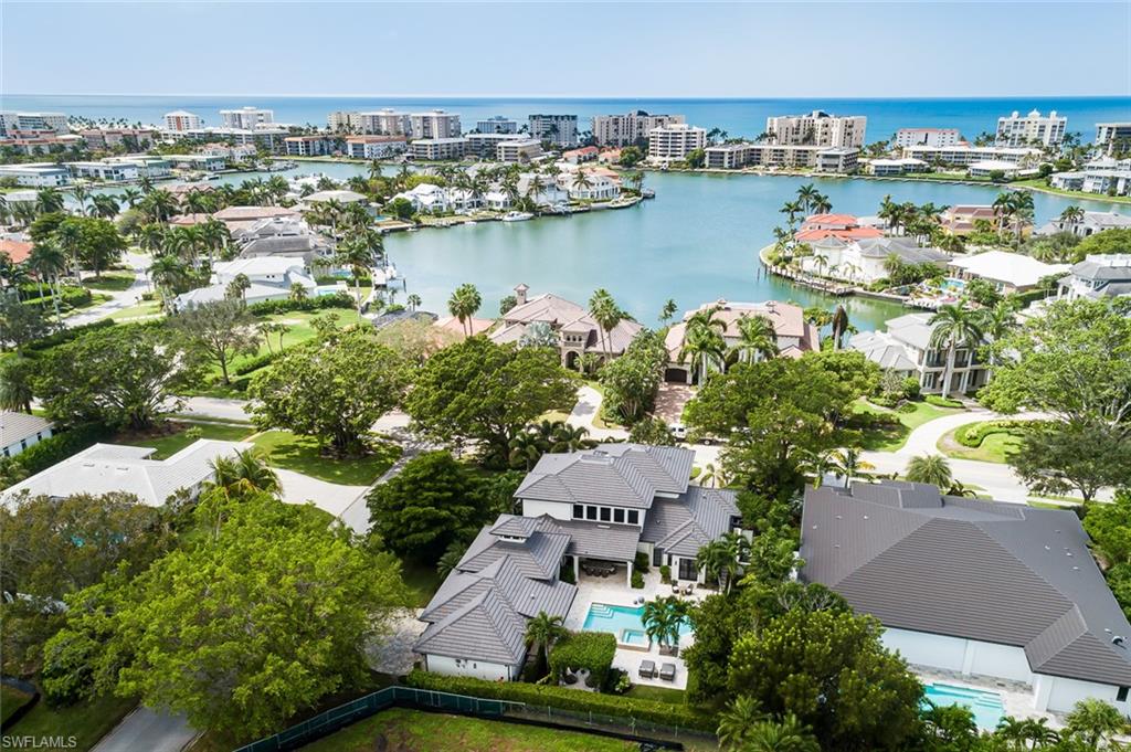 3170 Crayton Road Naples, FL 34103 - Photo 42 of 50 an aerial view of a house with a lake view