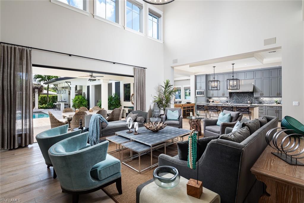3170 Crayton Road Naples, FL 34103 - Photo 7 of 50 a living room with furniture and a large window