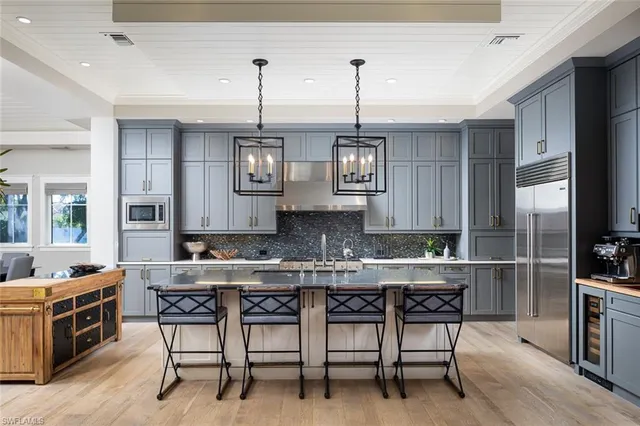 a kitchen with a table chairs stove and cabinets