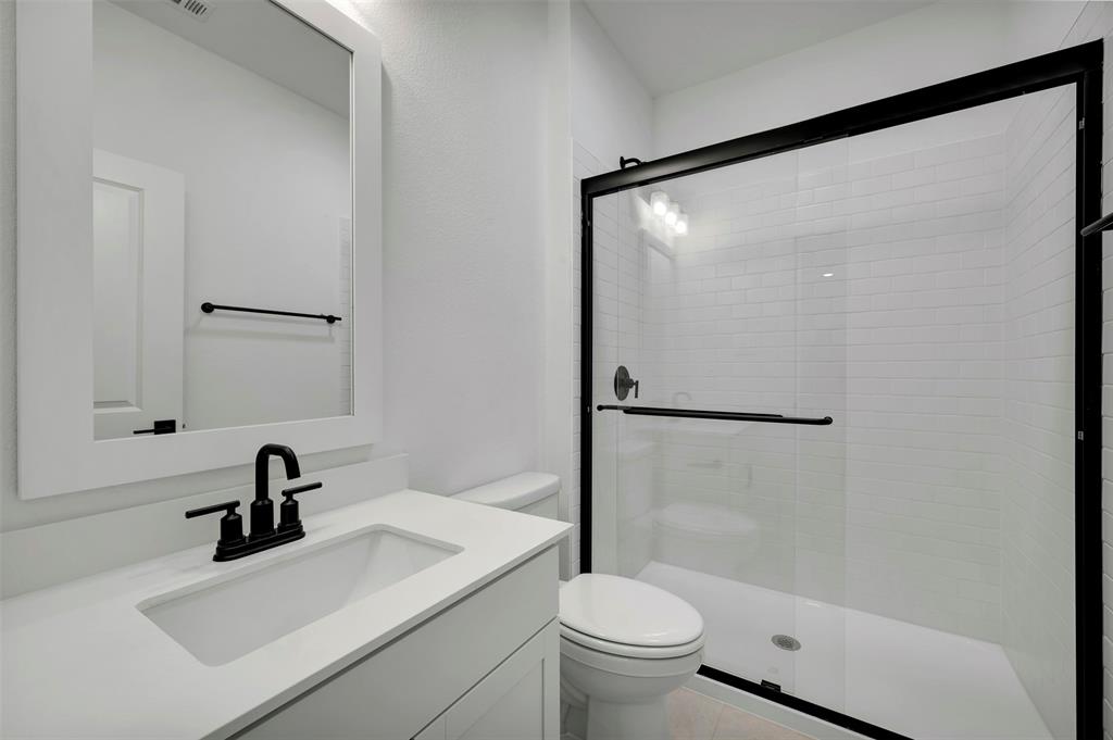 175 Summer Rain Way Newark, TX 76071 - Photo 17 of 39 a bathroom with a sink toilet and a mirror