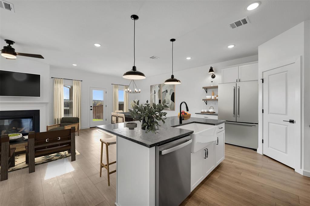 175 Summer Rain Way Newark, TX 76071 - Photo 6 of 39 a kitchen with stainless steel appliances granite countertop a sink refrigerator and cabinets