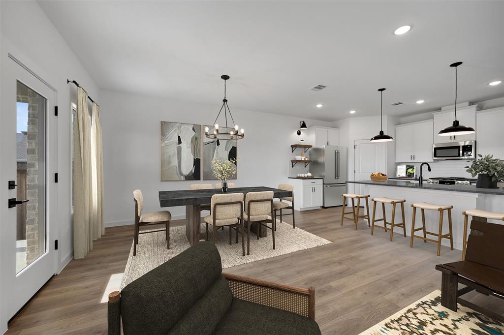 175 Summer Rain Way Newark, TX 76071 - Photo 8 of 39 a view of a dining room and livingroom with furniture wooden floor a rug a chandelier