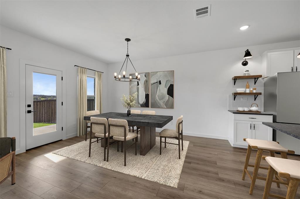 175 Summer Rain Way Newark, TX 76071 - Photo 9 of 39 a view of a dining room with furniture and wooden floor