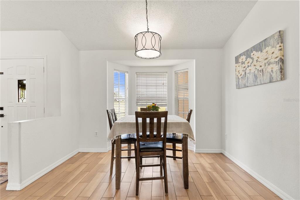 9917 Nelson Road Dade City, FL 33525 - Photo 19 of 40 a view of a dining room with furniture window and wooden floor