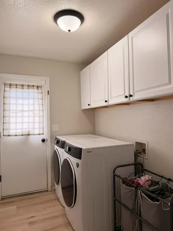 a utility room with sink dryer and washer