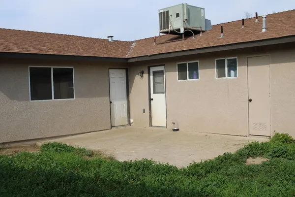 a front view of a house with plants