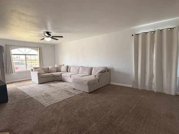 a living room with furniture and a chandelier