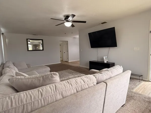 a living room with furniture and a flat screen tv