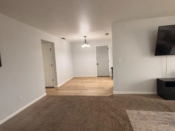 a view of an empty room with a flat screen tv