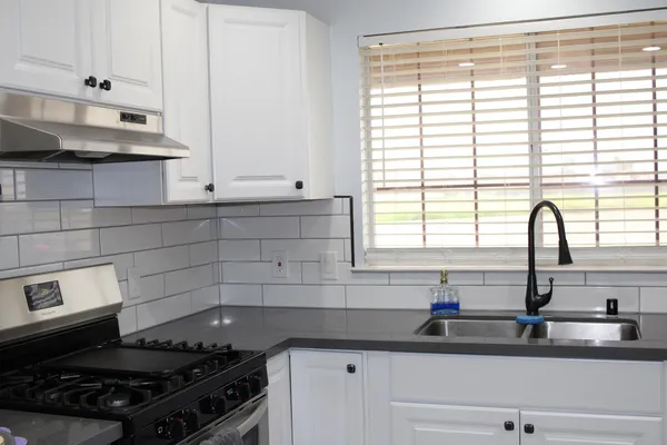 a kitchen with granite countertop a sink and a window
