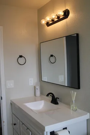 a bathroom with a sink and mirror