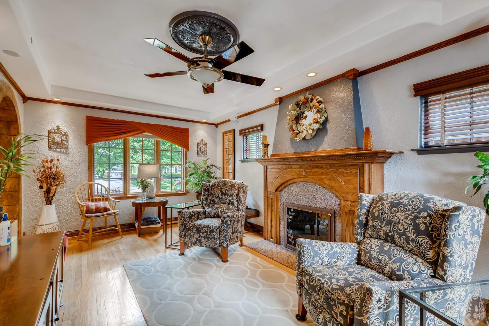 300 Blythe Road Riverside, IL 60546 - Photo 6 of 31 a living room with furniture a chandelier and a fireplace