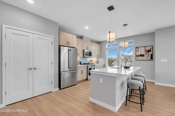 a kitchen with a stove a microwave and cabinets