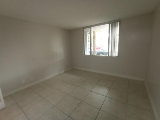 941 Lyons Road, Unit 5105 Coconut Creek, FL 33063 - Photo 13 of 22 an empty room with a window