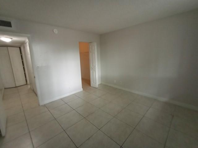 941 Lyons Road, Unit 5105 Coconut Creek, FL 33063 - Photo 14 of 22 en empty room with windows