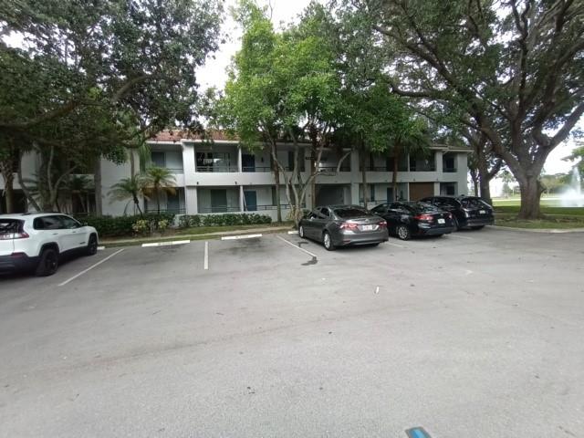 941 Lyons Road, Unit 5105 Coconut Creek, FL 33063 - Photo 16 of 22 a car parked in front of a building
