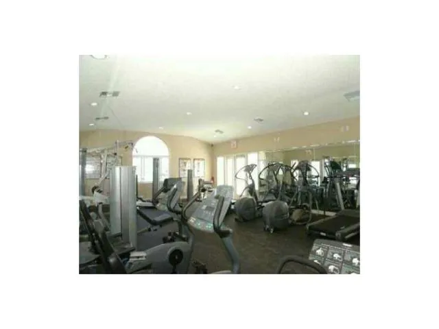 a view of a patio with chairs under an umbrella