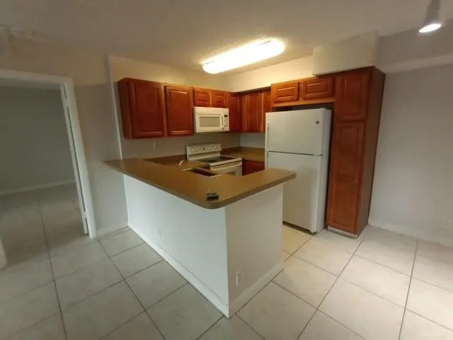 a kitchen with stainless steel appliances a refrigerator sink and cabinets