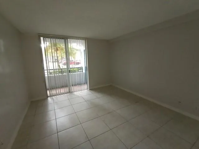 a view of an empty room with glass door