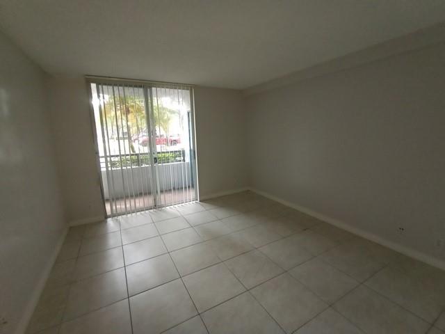 941 Lyons Road, Unit 5105 Coconut Creek, FL 33063 - Photo 6 of 22 a view of an empty room with glass door