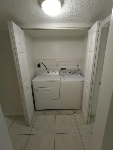 941 Lyons Road, Unit 5105 Coconut Creek, FL 33063 - Photo 10 of 22 a utility room with dryer and washer