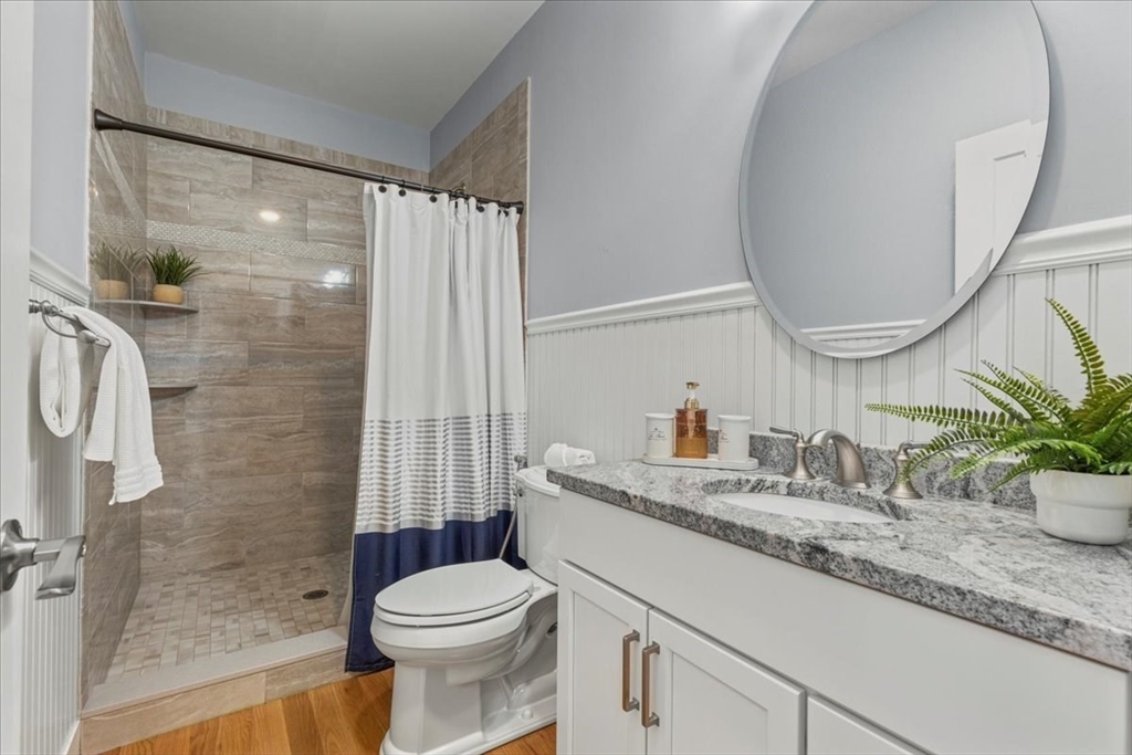 4 Lost Brook Trail Walpole, MA 02081 - Photo 14 of 42 a bathroom with a granite countertop sink toilet and shower