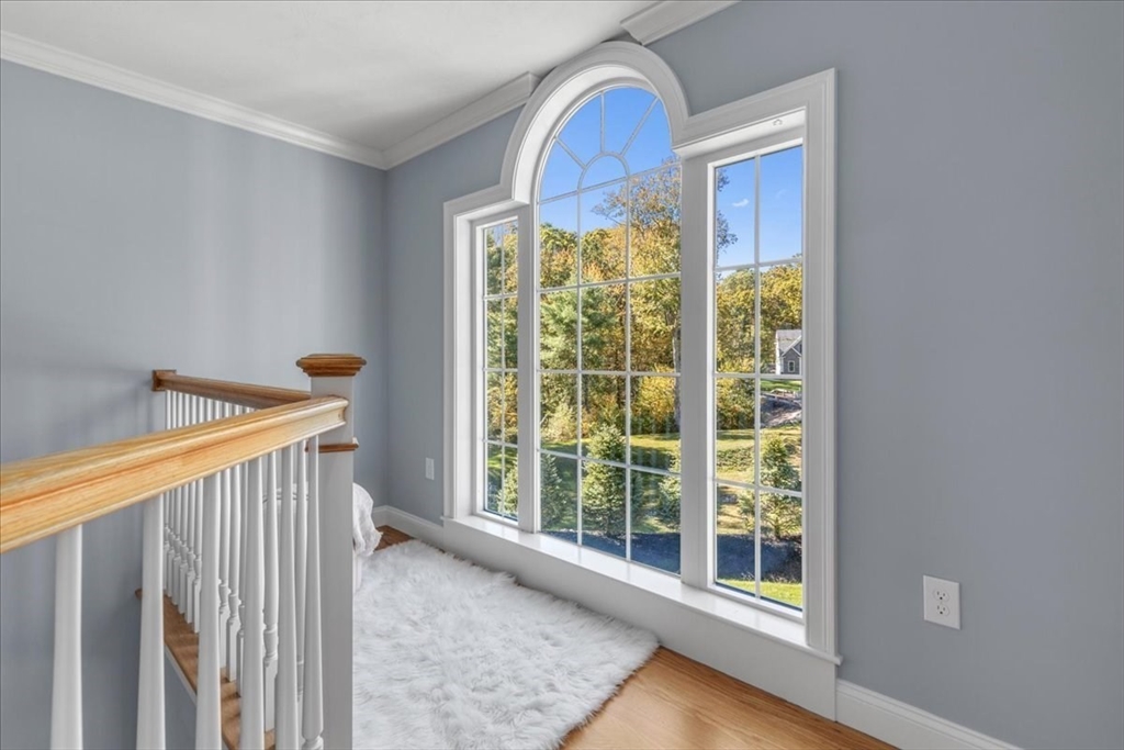 4 Lost Brook Trail Walpole, MA 02081 - Photo 20 of 42 a view of a room that has a window and wooden floor