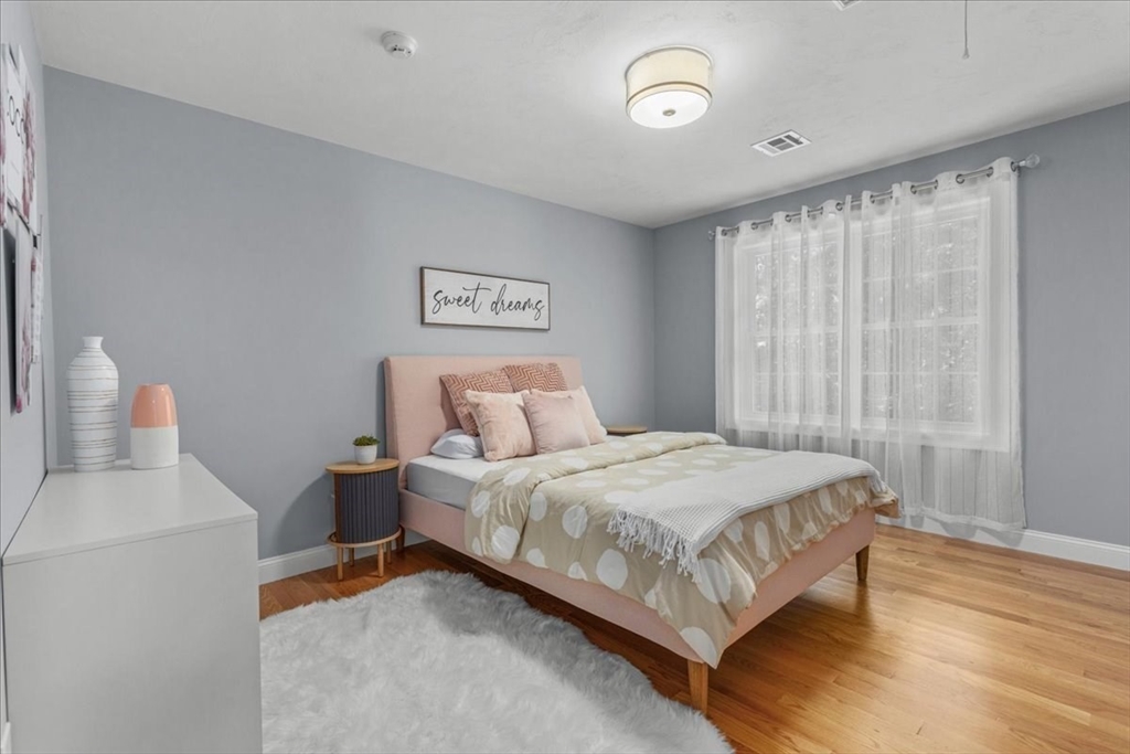 4 Lost Brook Trail Walpole, MA 02081 - Photo 26 of 42 a bedroom with a bed and a white wall painting