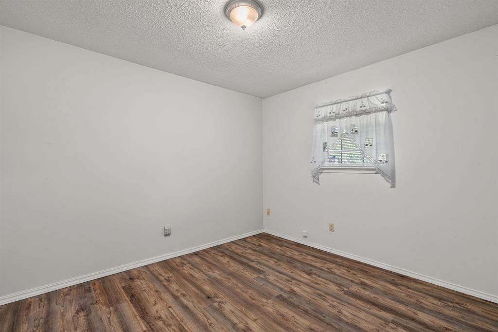 337 Town N Drive Terrell, TX 75160 - Photo 15 of 30 a view of a room with wooden floor and windows