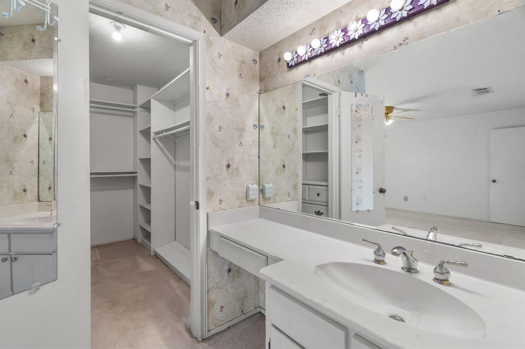 337 Town N Drive Terrell, TX 75160 - Photo 19 of 30 a spacious bathroom with a sink mirror and a shower