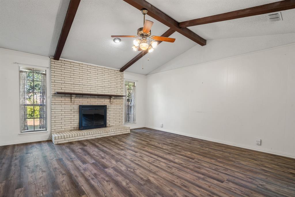 337 Town N Drive Terrell, TX 75160 - Photo 5 of 30 a view of an empty room with wooden floor fireplace and a window