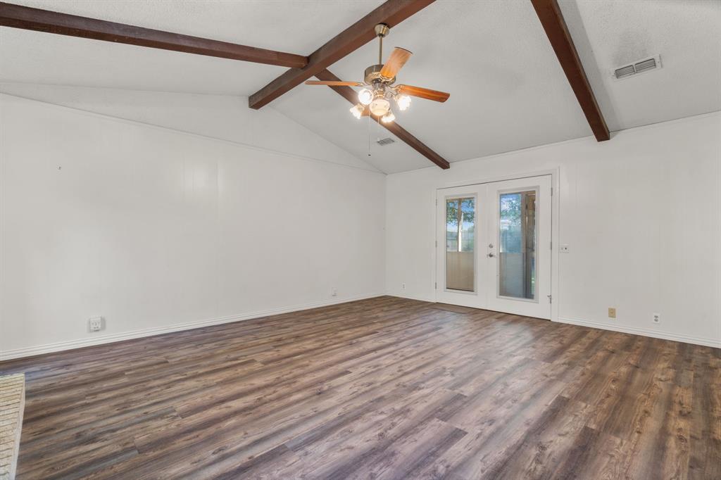 337 Town N Drive Terrell, TX 75160 - Photo 6 of 30 a view of an empty room with wooden floor and a window