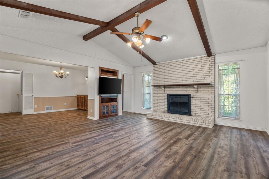 337 Town N Drive Terrell, TX 75160 - Photo 7 of 30 a view of a livingroom with an empty kitchen and a fireplace