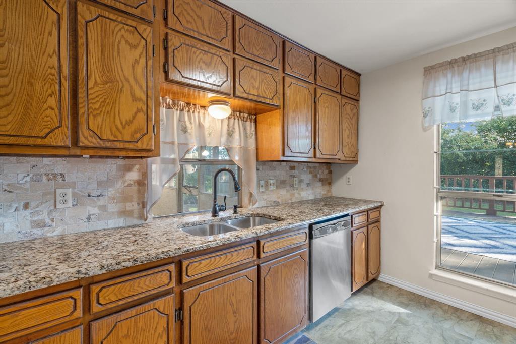 337 Town N Drive Terrell, TX 75160 - Photo 10 of 30 a kitchen with granite countertop a sink and a window