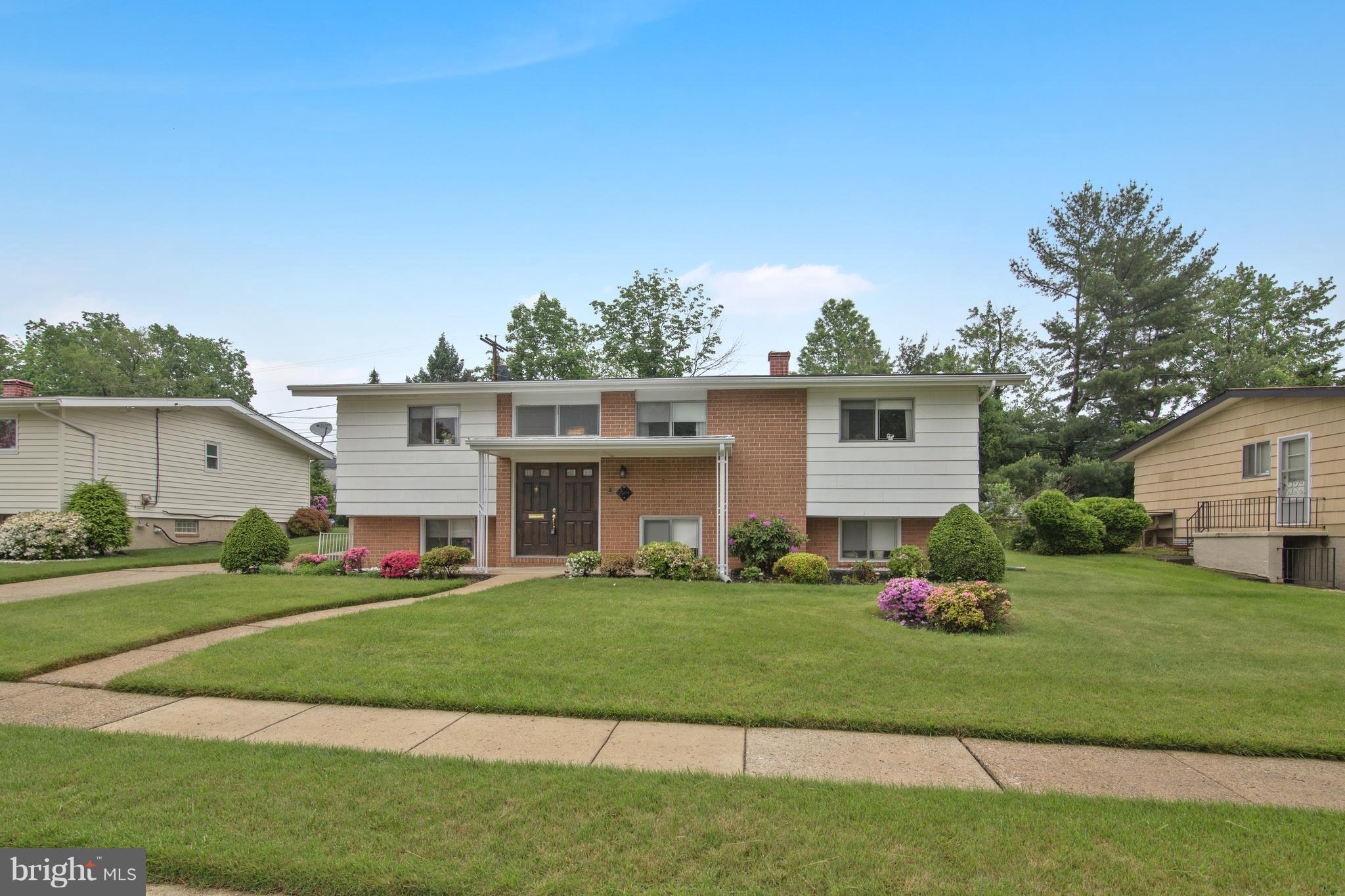 7504 Shelowood Road Baltimore, MD 21208 - Photo 2 of 29 a front view of a house with a yard and trees