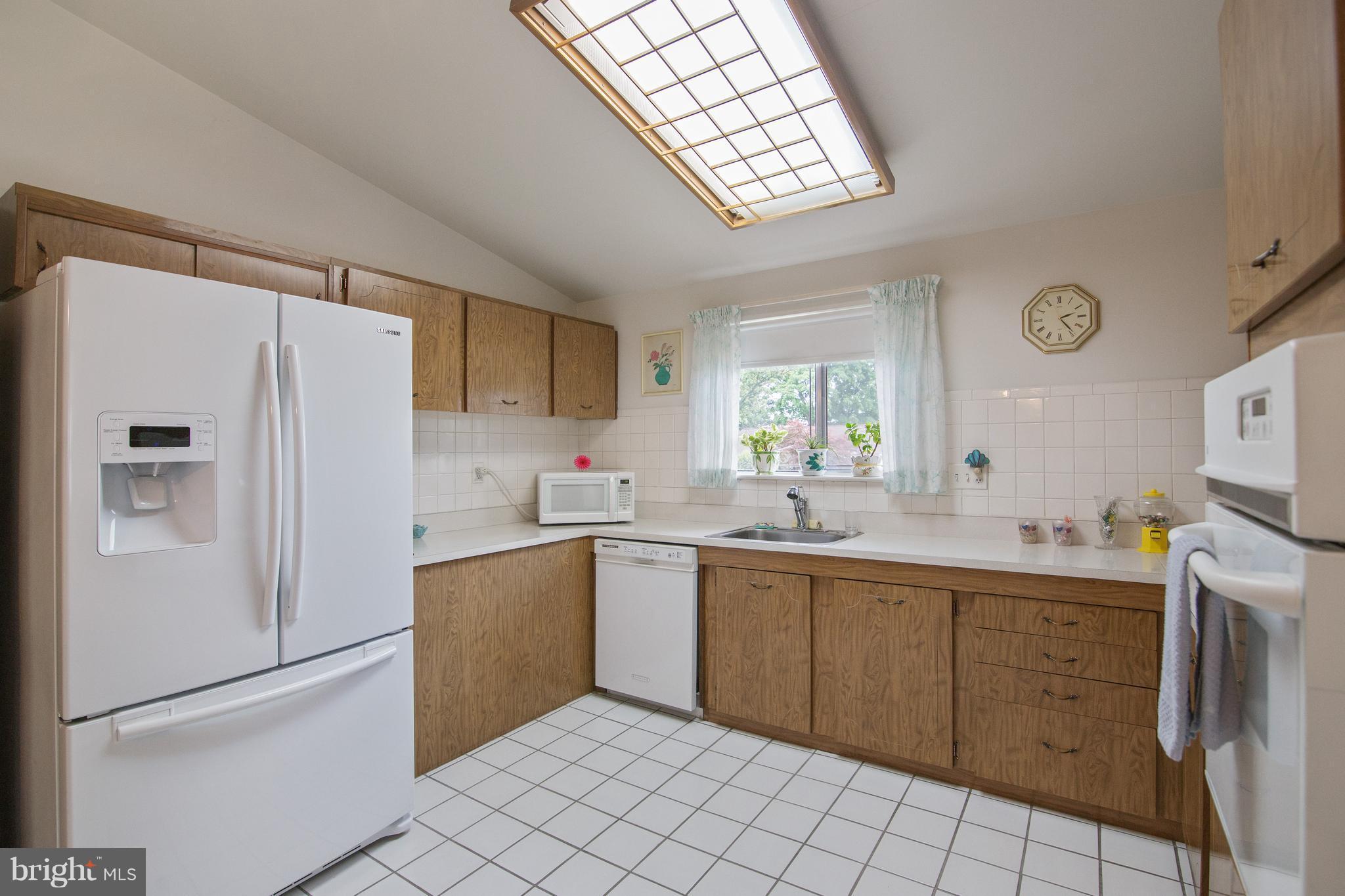 7504 Shelowood Road Baltimore, MD 21208 - Photo 12 of 29 a kitchen with a sink appliances and cabinets
